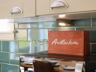 A kitchen with wooden box and microwave at Ardlochan Lodge - Culzean Castle in Maybole
