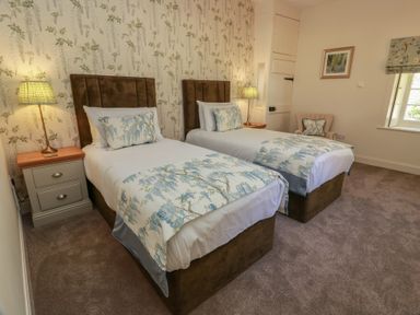 A bedroom with two beds and a lamp at Ardlochan Lodge - Culzean Castle Maybole
