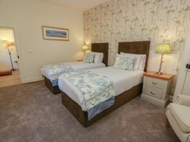 A bedroom with two beds and nightstand at Ardlochan Lodge - Culzean Castle Maybole