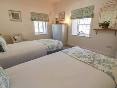 A bedroom with two beds and a dresser at Ardlochan Lodge - Culzean Castle in Maybole