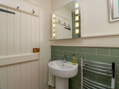 A bathroom with a sink and mirror at Ardlochan Lodge - Culzean Castle Maybole
