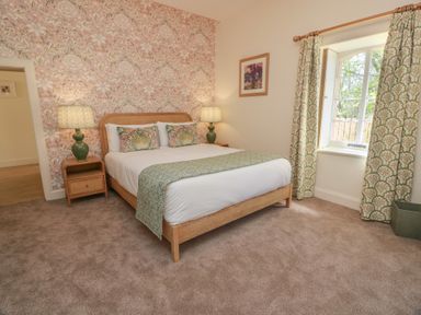 A bedroom with a bed and lamps at Ardlochan Lodge - Culzean Castle Maybole