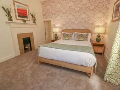 A bedroom with a bed and bedside tables at Ardlochan Lodge - Culzean Castle in Maybole