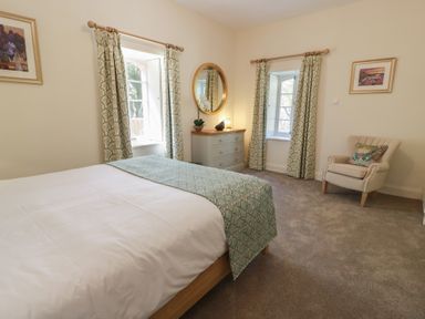 A bedroom with a bed and dresser at Ardlochan Lodge - Culzean Castle, Maybole