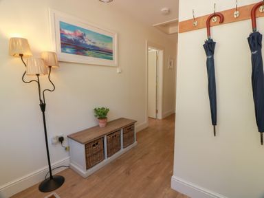 A hallway with a lamp and storage unit at Ardlochan Lodge - Culzean Castle in Maybole