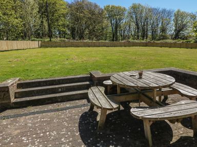 A garden area with a wooden table and benches at Ardlochan Lodge - Culzean Castle in Maybole