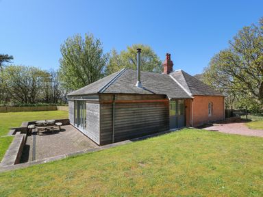 An outdoor area with a house and seating at Ardlochan Lodge - Culzean Castle Maybole