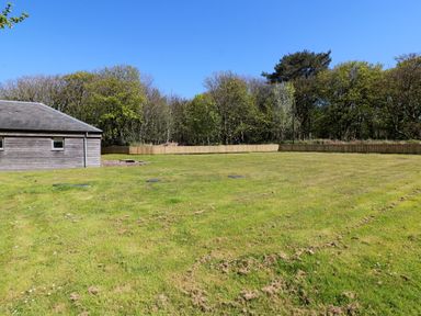 A garden area with a house and trees at Ardlochan Lodge - Culzean Castle in Maybole