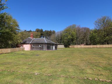 A house with a large grassy area and trees at Ardlochan Lodge - Culzean Castle in Maybole