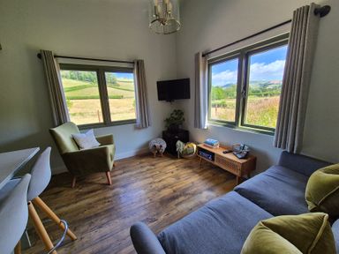 A living room with a sofa and chairs at Birch Banc Retreats - Bedw Llanidloes