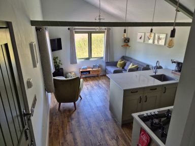 A living room with a coffee table and sofa at Birch Banc Retreats - Bedw Llanidloes