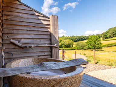 A bathtub on a wooden deck at Birch Banc Retreats - Bedw Llanidloes