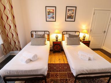 A bedroom with two single beds and decor at Maples in Hunstanton