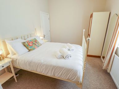 A bedroom with a bed and wardrobe at Maples in Hunstanton