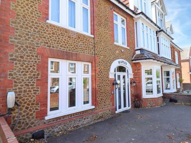 A building with stone and brick exterior at Maples in Hunstanton
