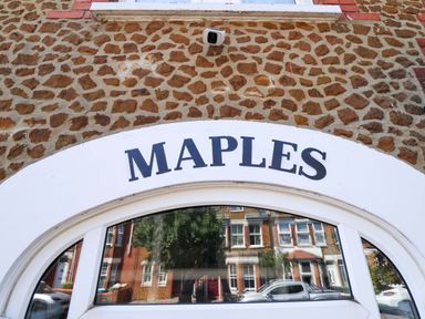 A sign reading MAPLES on a building at Maples in Hunstanton