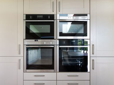 A kitchen wall with built in ovens and cabinets at Silverholme in Graythwaite near Hawkshead