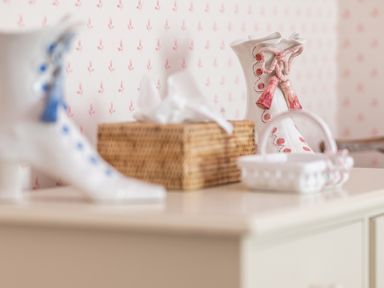 A dresser with ceramic decorative items and a wicker tissue box on a surface at Silverholme Graythwaite near Hawkshead