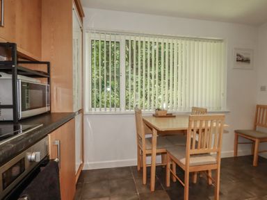 A kitchen with a table and chairs at 49 Atlantic Reach in Newquay