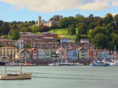 A waterfront with colorful houses and boats docked on the water at 4 Dartview in Dartmouth