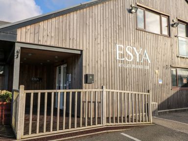 An entrance to a wooden building with a sign reading ESYA Retallack Spa Health Club at Redwood Retallack near St Columb Major