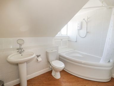 A bathroom with a sink toilet bathtub and shower at The Nook in Benllech