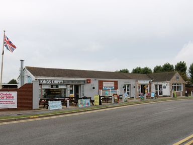 A commercial building with a fish and chips shop and reception area on a roadside at 98 Cherry Park in Chapel St Leonards