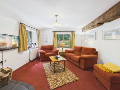 A living room with sofas and a coffee table at The Roundhouse in Warbstow