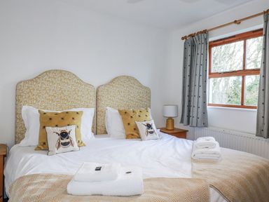 A bedroom with two beds and a nightstand at Tresawle in Crantock