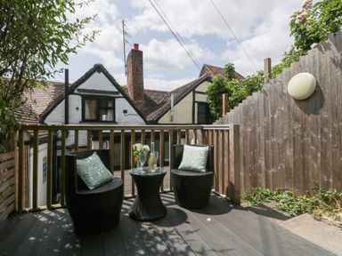 An outdoor seating area with two chairs and a table at Avonmede in Tewkesbury