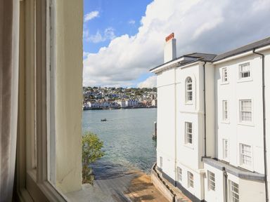 A view of waterfront and buildings across the water from a window at Ferrystone Kingswear near Dartmouth