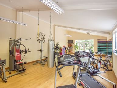 A gym room with exercise machines a punching bag weights and treadmills at Valley View in Mullion