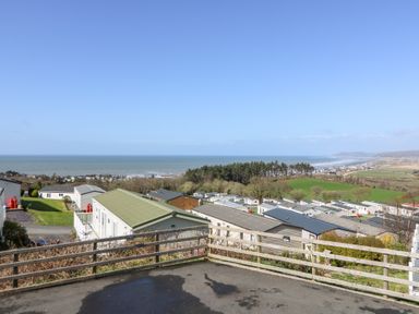 A coastal area with rows of mobile homes near the sea at McAuliffe Lodge in Borth