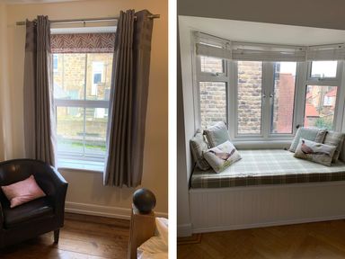 A room with a window with gray curtains and a black chair with a pink pillow and a seating nook with a plaid cushion and bird-patterned pillows at A Stone's Throw in Alnmouth