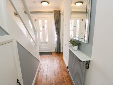 A hallway with front door and shelf at Glasfryn in Holyhead