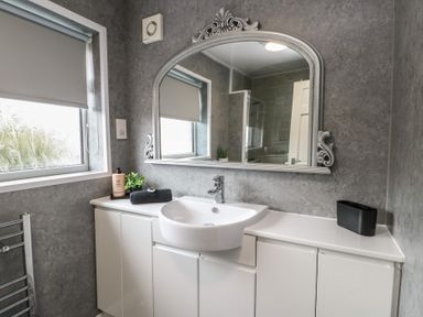 A bathroom with a sink and mirror at Glasfryn in Holyhead