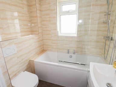 A bathroom with a bathtub shower toilet and a sink at Oakhurst in Keswick