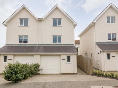 Two modern semi detached houses with garages and windows at 3 Lon Y Dryw in Trearddur Bay