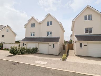 Two semi detached houses with garages and driveway in front at 3 Lon Y Dryw in Trearddur Bay