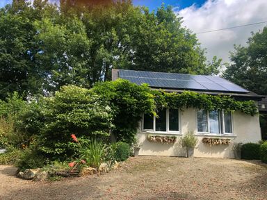 A house with solar panels on the roof and plants in front at Primrose End in Jacobstow