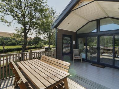 An outdoor area with a table and chairs at Hares Rest in Nantmel near Rhayader