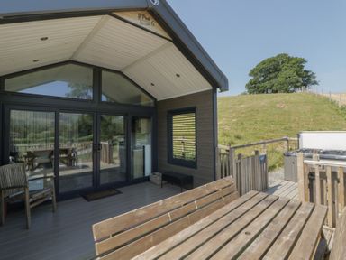 An outdoor patio with seating and a hot tub at Hares Rest Nantmel near Rhayader