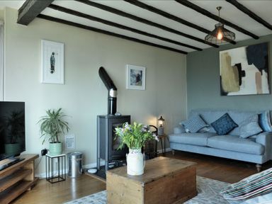 A living room with a sofa and coffee table at Ocean View in Downderry