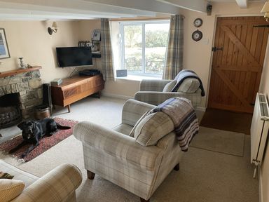 A living room with a television and fireplace at Penllain Newport, Pembrokeshire