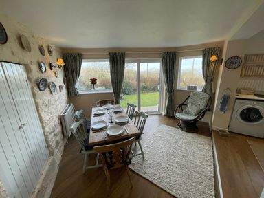 A dining area with a table and chairs at Penllain, Newport, Pembrokeshire
