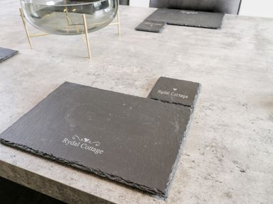 A table with slate placemats labeled Rydal Cottage at Rydal Cottage in Scarborough