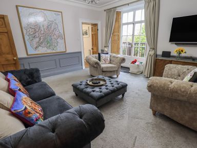 A living room with a map on the wall at Red Screes in Ambleside