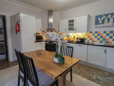 A kitchen with a table and chairs at Red Screes in Ambleside