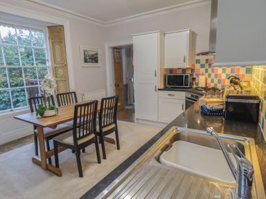A kitchen with table and chairs at Red Screes in Ambleside