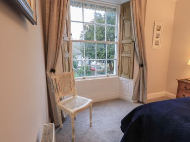 A bedroom with a window and a chair at Red Screes in Ambleside